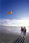 Family Flying Kite on Beach