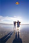 Family Flying Kite on Beach