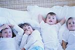 Four Children Lying on Bed