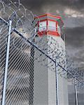 Prison Tower behind Barbed Wire
