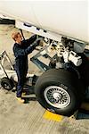 Airplane Mechanic Working on Landing Gear