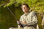 Man Fishing in Boat Long Pond, Belgrade Lakes Maine, USA