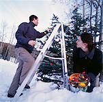 Couple Putting up Christmas Lights