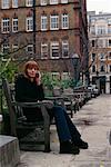 Girl on Bench with Cellular Phone London England