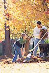 Father and Daughter Raking Leaves