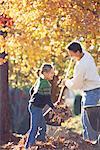 Father and Daughter Raking Leaves