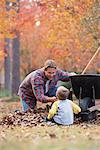Father and Son Raking Leaves