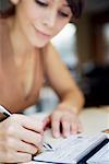 Woman Writing in Chequebook