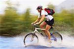 Woman Crossing River on Mountain Bike