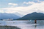 Girl in Glacial Lake Alsek Lake, Alaska, USA