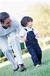 Boy Learning to Walk with Father