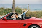 Man in Sports Car with Surfboard