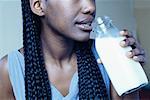 Close-Up of Woman Drinking Milk From Bottle