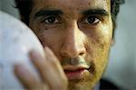 Man with Dirty Face and Soccer Ball