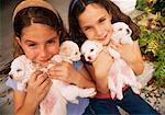 Girls Holding Puppies