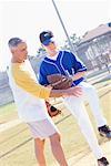 Man Coaching Boy with Pitching