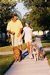 Father and Daughter Walking Dogs