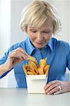 Woman Eating French Fries
