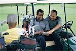 Golfers Looking at Score Cards