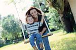 Mother Pushing Son on Swing