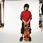 Boy with Skateboard in Studio