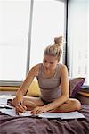 Woman Paying Bills in Bedroom