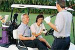 Couple in Golf Cart, Talking to Friend