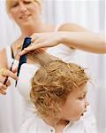 Woman Cutting Child's Hair