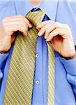 Close-Up of Businessman Tying Necktie