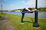 Woman Stretching in Park