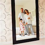 Family Reflected in Bedroom Mirror