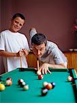 Father and Son Playing Minature Billiards