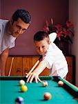 Father and Son Playing Miniature Billiards