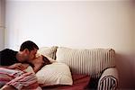 Couple Kissing on Sofa Bed