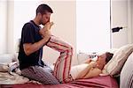 Man Kissing Woman's Feet in Bed