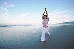 Woman Doing Yoga on Beach