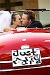 Bride and Groom Kissing in Car