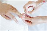 Woman receiving manicure treatment