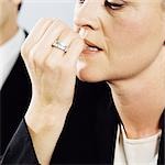 A businesswoman biting her nails