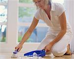 Woman Cleaning up Broken Glass