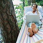 Woman Using Laptop on Hammock