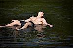 Man Sunbathing in Lake