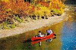 Couple Canoeing Down River Alberta, Canada