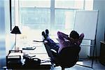 Businessman with Feet Up in Office