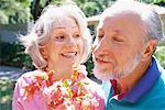 Couple Smelling Flowers