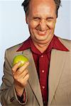 Man Holding Apple and Laughing