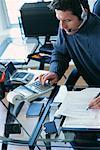 Businessman Using Adding Machine