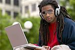 Man with Headphones and Laptop Computer