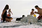 Family Building Sandcastle on The Beach