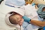 Newborn Baby Being Swaddled in Blanket
